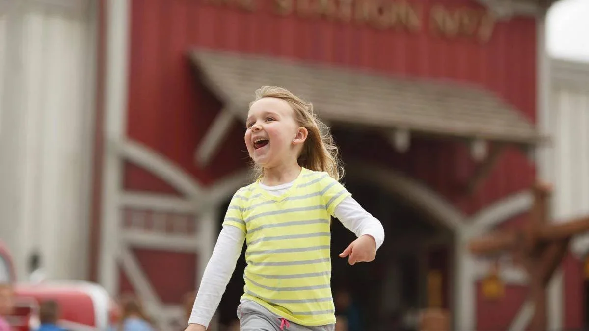 toddler skipping in front of Fire Station Number 7 at Dollywood